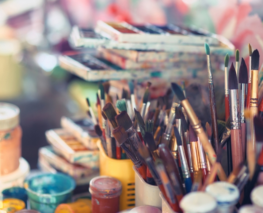 Paint Brushes And Watercolor Paints On The Table In A Workshop, Selective Focus, Close Up.